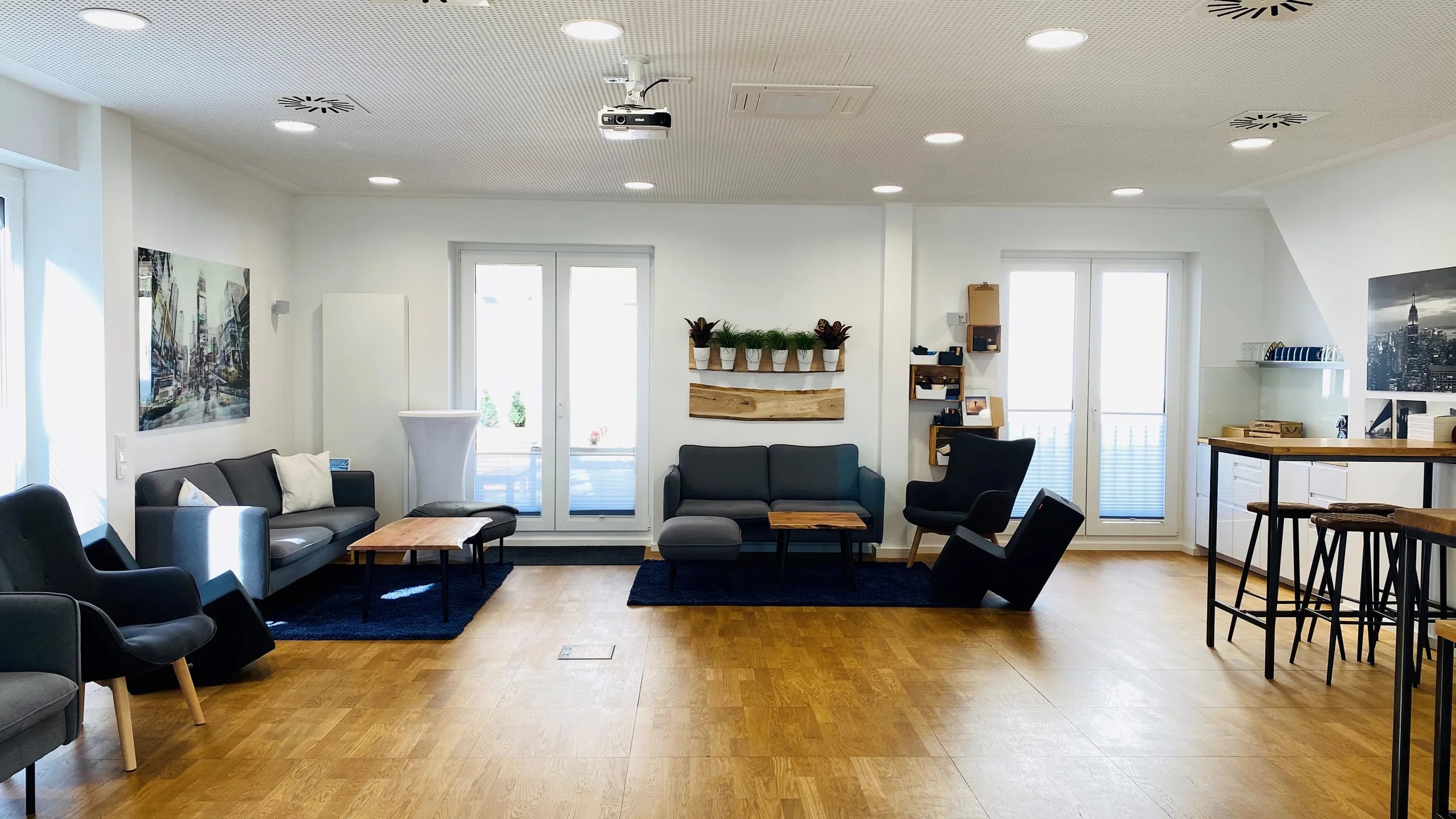 Seminarraum New York in Hannover mit Loungesofas, Stehtischen und Beamer